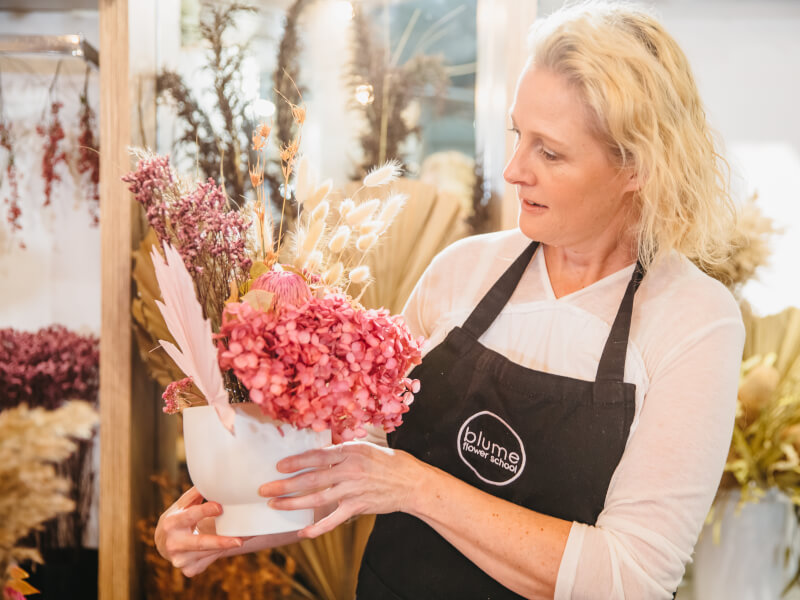 Blond woman holding a bouquet of flowers
